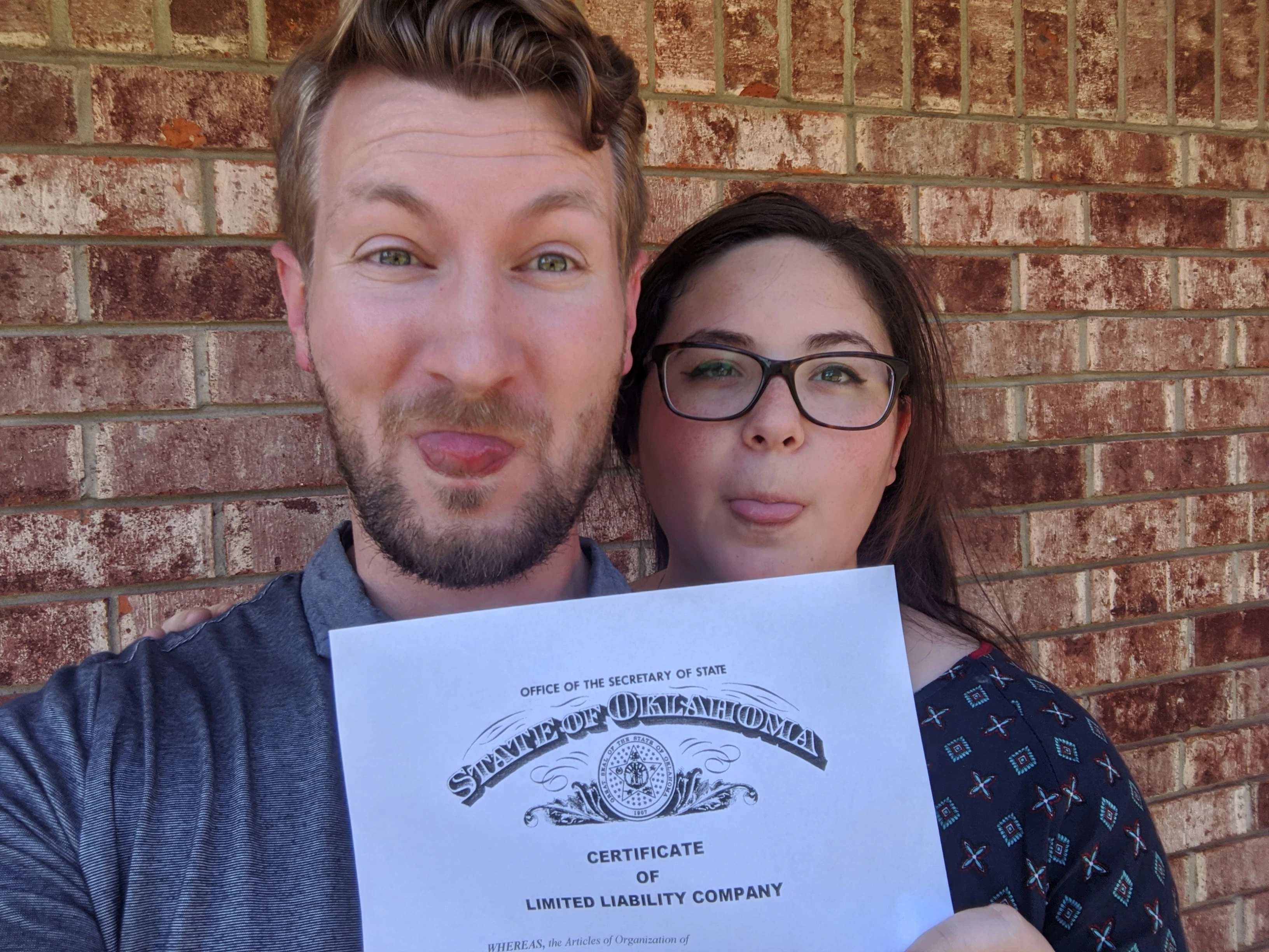 Garrett and Grace Hammonds holding the Hammonds Media business license